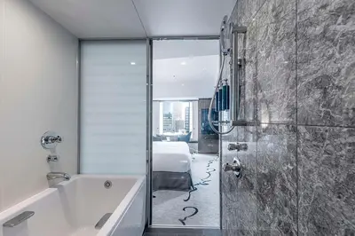 a bathroom with a bath tub and a bedroom at Hilton Tokyo Hotel in Tokyo