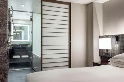 a bedroom with a walk in shower next to a bed at Hilton Tokyo Hotel in Tokyo