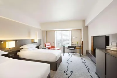 a hotel room with two beds and a desk at Hilton Tokyo Hotel in Tokyo