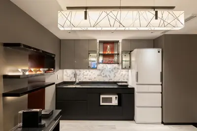a kitchen with a white refrigerator and a sink at Hotel New Otani Tokyo The Main in Tokyo