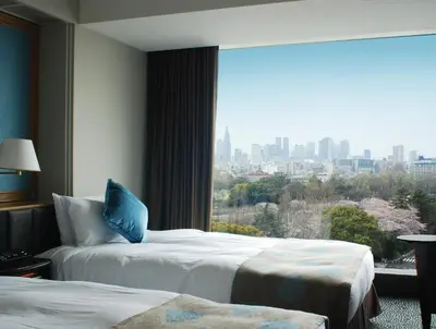 a hotel room with two beds and a large window at Hotel New Otani Tokyo The Main in Tokyo