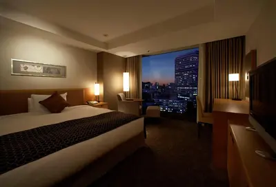 a hotel room with a bed and a view of a city at Hotel New Otani Tokyo The Main in Tokyo