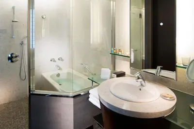a bathroom with a sink and a shower and a tub at The Strings by InterContinental, Tokyo by IHG in Tokyo