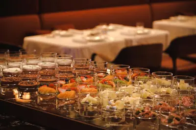 a table topped with appetizers and food in glasses at Park Hyatt Tokyo in Tokyo