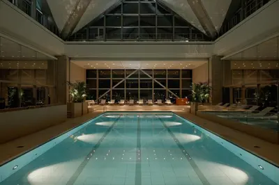 a large swimming pool in a building with a large window at Park Hyatt Tokyo in Tokyo