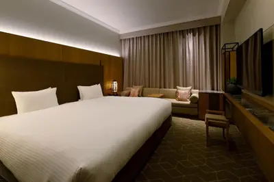 a hotel room with a large bed and a couch at Hotel The Celestine Tokyo Shiba in Tokyo