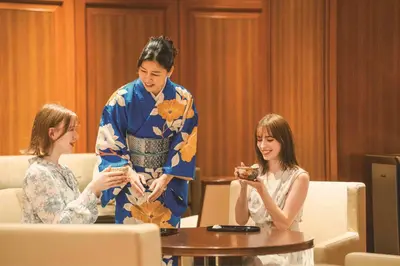 a man in a kimono standing at a table at Shiba Park Hotel in Tokyo