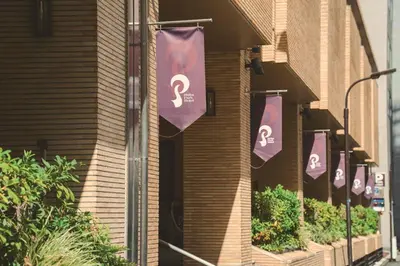a row of flags hanging on the side of a building at Shiba Park Hotel in Tokyo