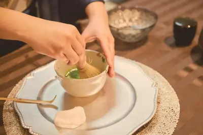 a person stirring a bowl with a whisk on a table at Shiba Park Hotel in Tokyo