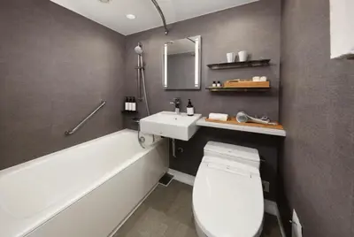 a bathroom with a toilet and a sink and a tub at Shiba Park Hotel in Tokyo