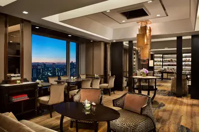 a restaurant with tables and chairs and a large window at Shangri-La Tokyo in Tokyo