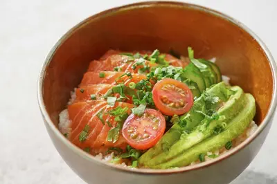 a bowl of food with salmon tomatoes and greens at Shangri-La Tokyo in Tokyo