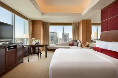 a hotel room with a large bed and a television at Shangri-La Tokyo in Tokyo