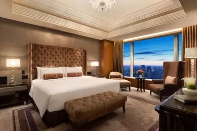 a bedroom with a large bed and a large window at Shangri-La Tokyo in Tokyo