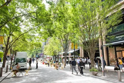 a rendering of a street with people walking on the sidewalk at Shangri-La Tokyo in Tokyo