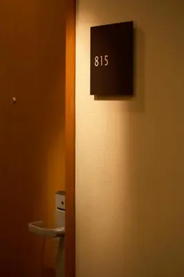 a bathroom door with a clock on the wall at the b akasaka in Tokyo