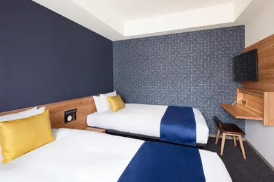 a hotel room with two beds and a tv at the b akasaka-mitsuke in Tokyo