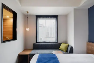 a small bedroom with a bed and a window at the b akasaka-mitsuke in Tokyo