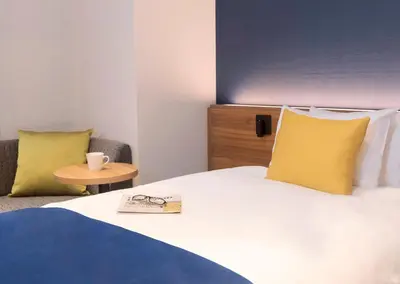 a hotel room with a bed with a book on it at the b akasaka-mitsuke in Tokyo