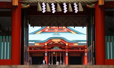 an entrance to a temple with people standing in it at the b akasaka-mitsuke in Tokyo