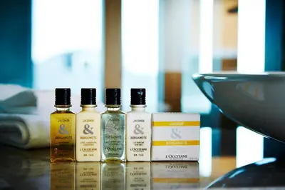 four bottles of essential oils sitting on a table at Keio Plaza Hotel Tokyo in Tokyo
