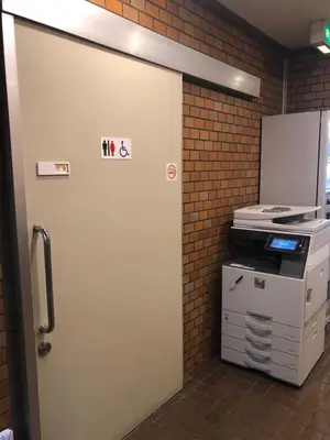 a white door in a room with a printer at Hotel Yanagibashi in Tokyo