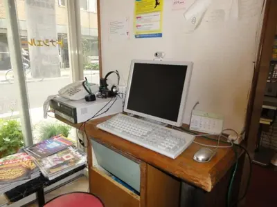 a desk with a computer and a keyboard and mouse at Hotel Yanagibashi in Tokyo