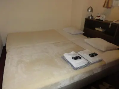 a bedroom with two towels on a bed at Hotel Yanagibashi in Tokyo