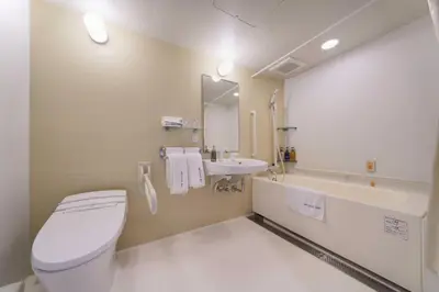 a bathroom with a toilet and a sink at Meitetsu Inn Hamamatsucho in Tokyo