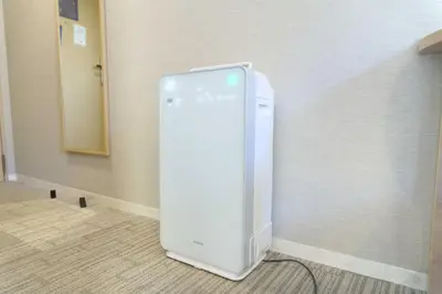 a white refrigerator in the corner of a room at Meitetsu Inn Hamamatsucho in Tokyo