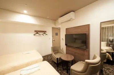 a hotel room with a bed and a flat screen tv at Sotetsu Fresa Inn Ginza-Nanachome in Tokyo