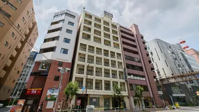 a tall building in the middle of a city at Tabist Hotel Tetora Ikebukuro in Tokyo