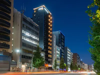 a tall building with a clock on top of it at APA Hotel Ochanomizu Ekikita in Tokyo