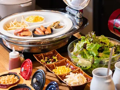 a buffet with plates of food and a salad at APA Hotel Ochanomizu Ekikita in Tokyo