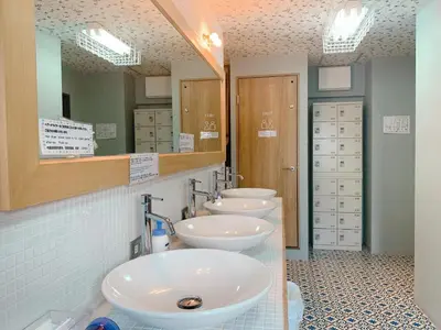 a bathroom with three sinks and two mirrors at Good Diner Inn Copain in Tokyo