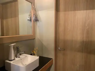 a bathroom with a sink and a wooden door at Good Diner Inn Copain in Tokyo