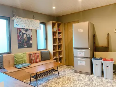 a living room with a couch and a refrigerator at Good Diner Inn Copain in Tokyo