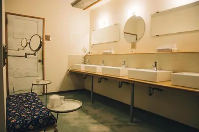 a bathroom with two sinks and a mirror at Nui. HOSTEL & BAR LOUNGE in Tokyo