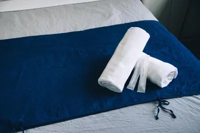 a pair of towels and a knife on a bed at Nui. HOSTEL & BAR LOUNGE in Tokyo