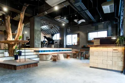 a large room with a table and benches in it at Nui. HOSTEL & BAR LOUNGE in Tokyo