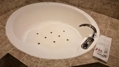 a bath tub with a faucet in a bathroom at AROMA+ (Adult Only) in Tokyo
