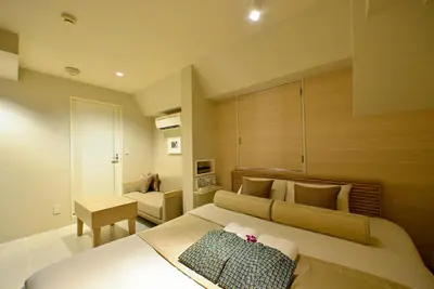 a bedroom with a bed and a desk in it at AROMA+ (Adult Only) in Tokyo