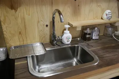 a kitchen sink with a soap dispenser next to it at Kagaribi Guesthouse in Tokyo