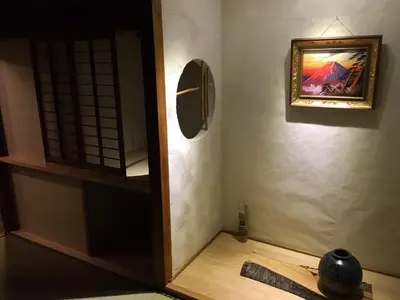 a room with a mirror and a painting on the wall at Kagaribi Guesthouse in Tokyo