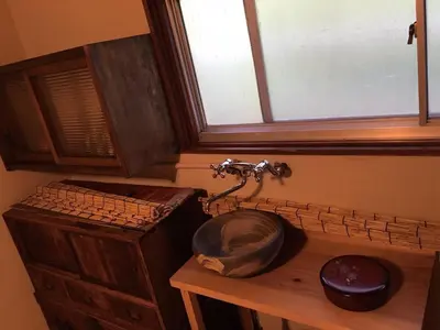 a bathroom with a sink and a window at Kagaribi Guesthouse in Tokyo