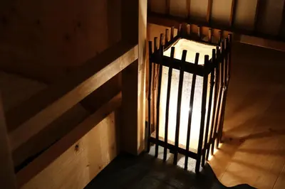 a staircase with a metal railing in a stair case at Kagaribi Guesthouse in Tokyo