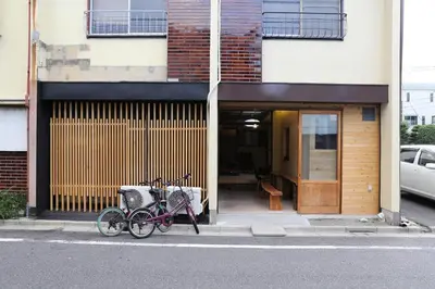 two bikes parked on a sidewalk in front of a building at Kagaribi Guesthouse in Tokyo