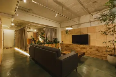 a living room with couches and a flat screen tv at DENCHI TOKYO - Private Designer Stay in Asakusa in Tokyo