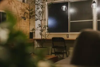 a chair sitting in front of a window with a plant at DENCHI TOKYO - Private Designer Stay in Asakusa in Tokyo