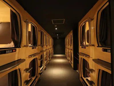 a dark hallway with a row of trains at Gran Custama Ueno in Tokyo